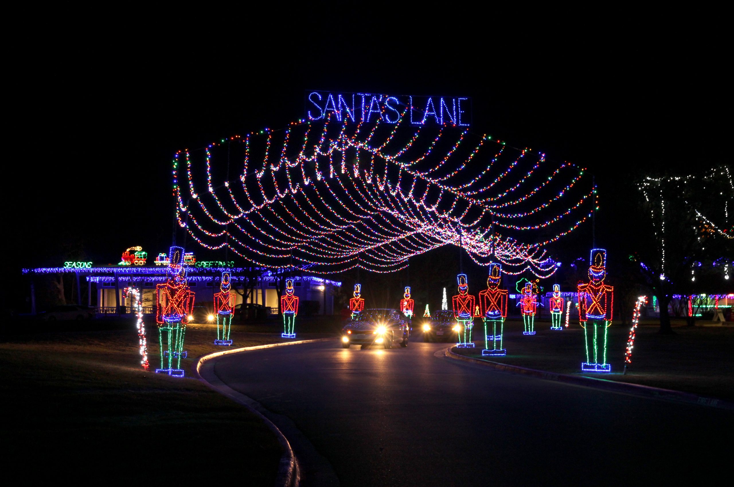Santa's Lane spelled out over lights that look like tin soldiers. 