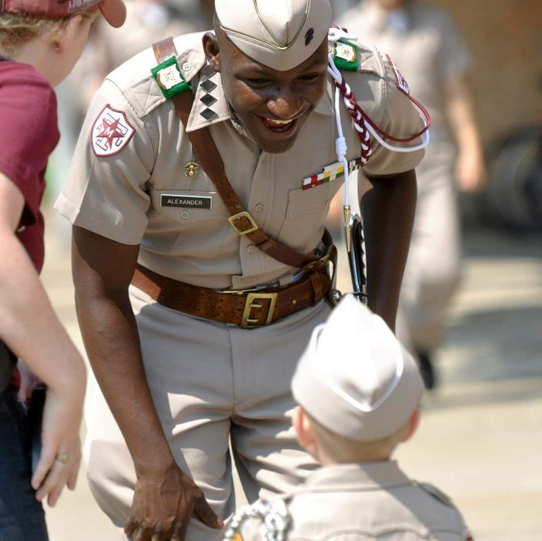 Marquise greets a young boy eager to meet the Commander of the Corps.