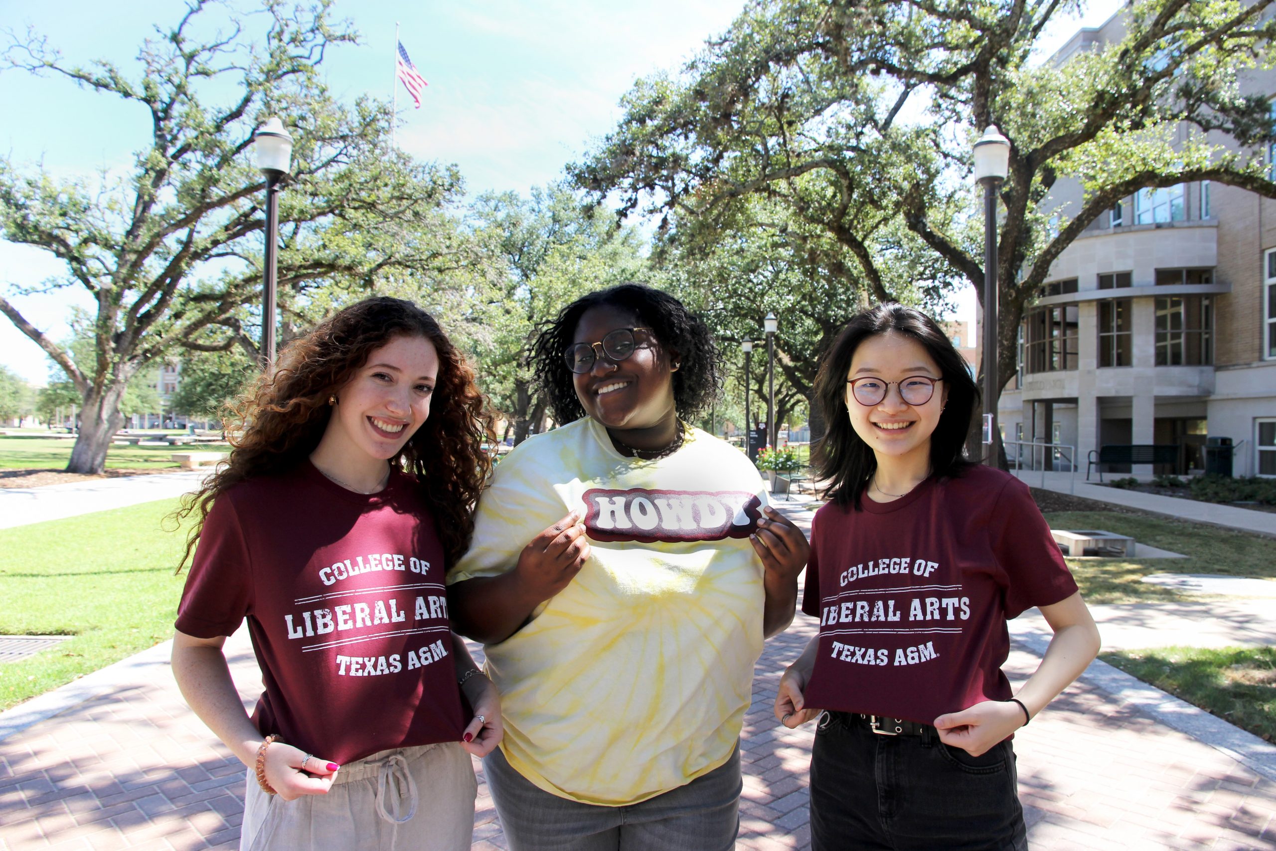 Stella and two friends pause for a photo to show off their College of Liberal Arts t-shirts.