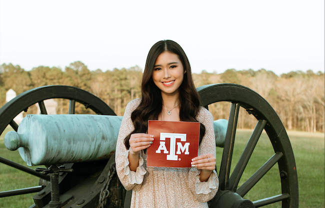 Madelaine Setiawan poses for a photo holding her acceptance letter from Texas A&M University.