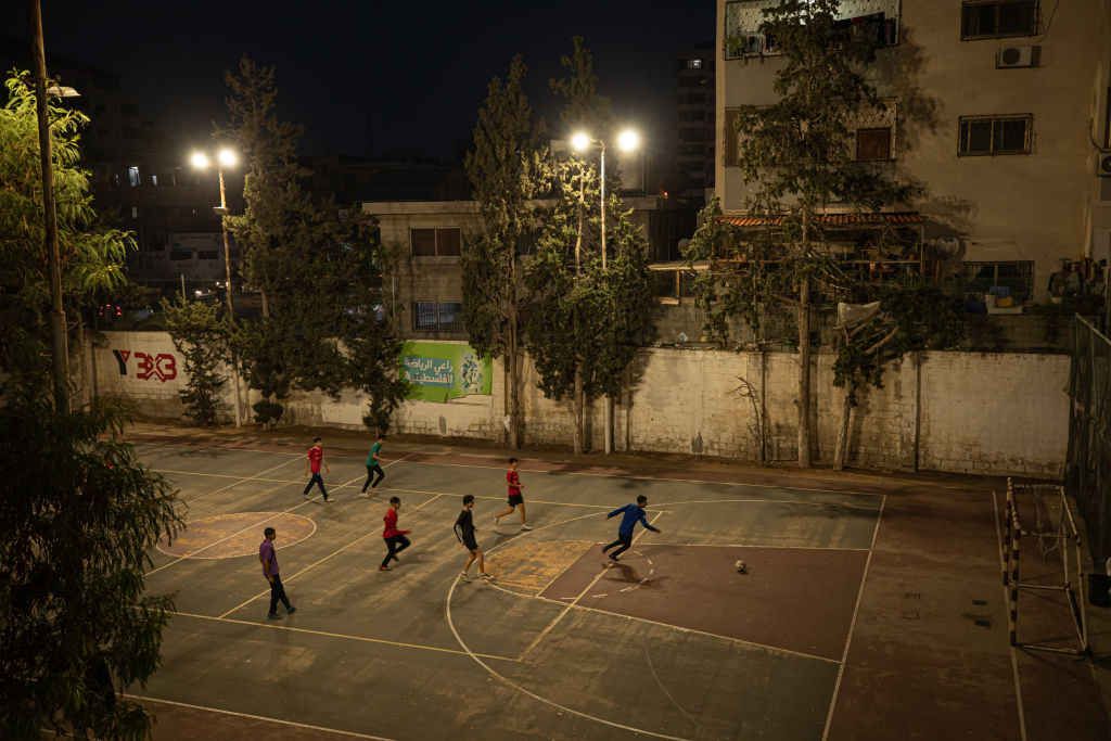 Palestinian youth playing football (known more commonly as soccer in the United States).