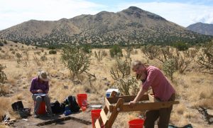 woman sifting soil in New Mexico desert